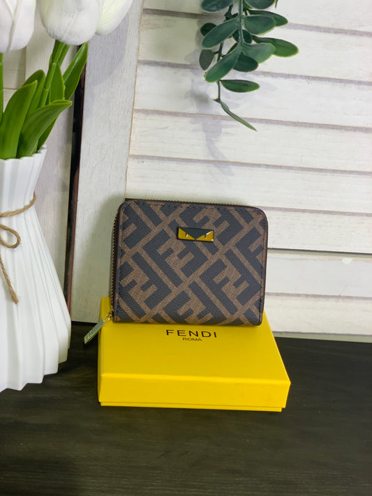 Two small Fendi purses with a box