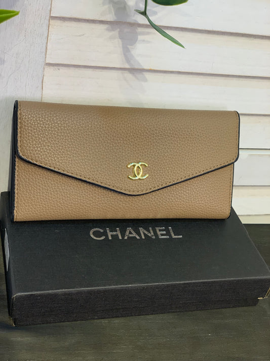 Two large beige Chanel purses with a box