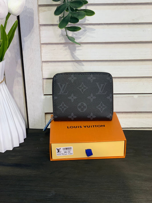 Two small Louis Vuitton purses with a box