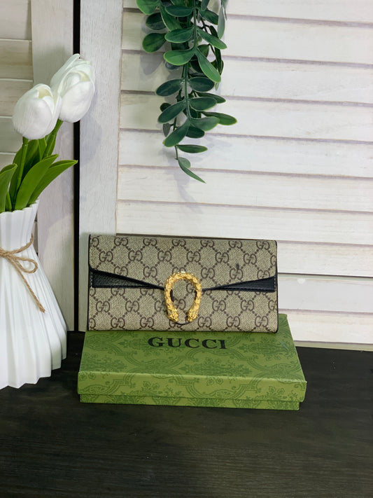 Two large Gucci wallets, beige and black, with a box